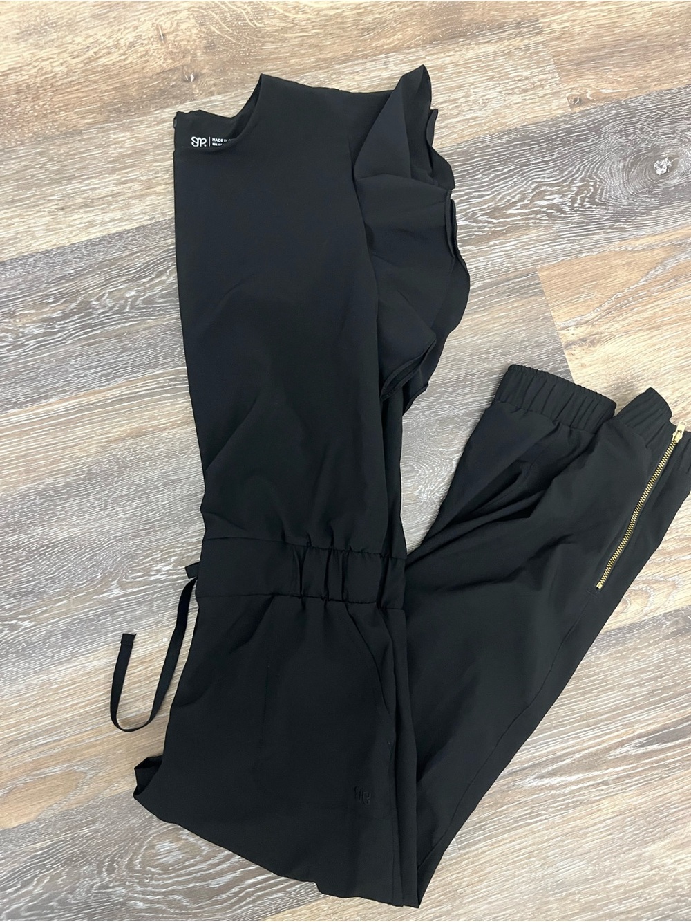 Albion Fit Black Ruffle-Detail Jumpsuit with Ankle Zips